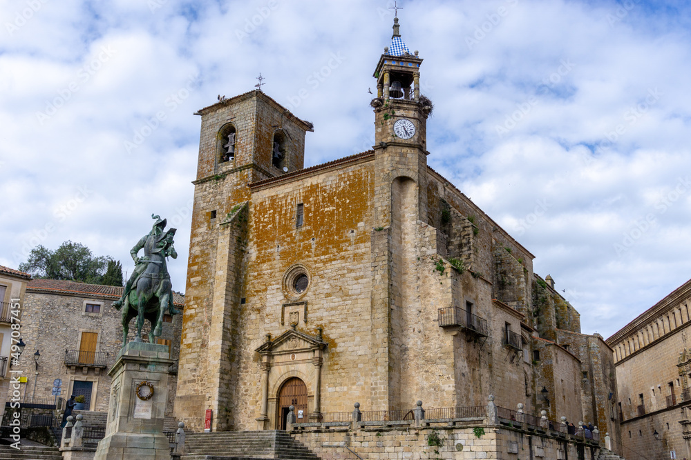 view of the statue and church in the Plaza Mayor Square in historic old town Trujillo