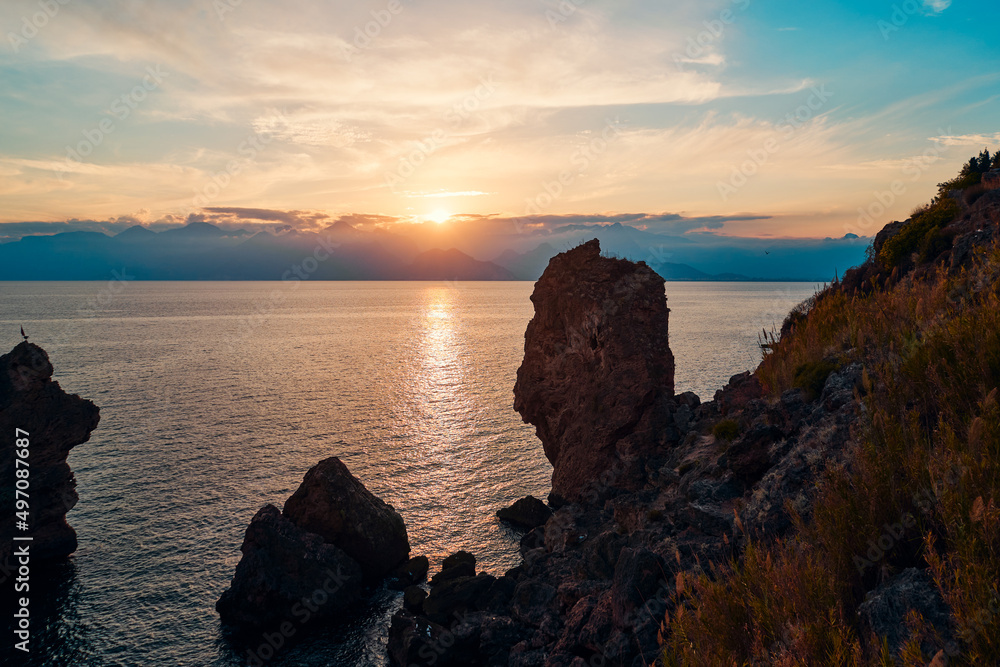 Sea cliffs and rocks on the Antalya coast. Beautiful sunset landscape.