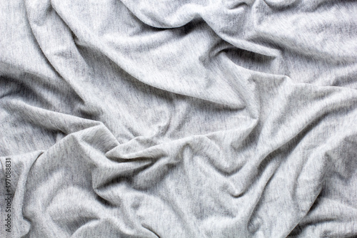 Grey crumpled fabric background for your design. Knitwear cotton abstract texture