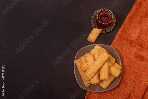 Biscuits El Eid , Biscuits of Eid ul fitr Islamic Feast with red tea on a wooden table