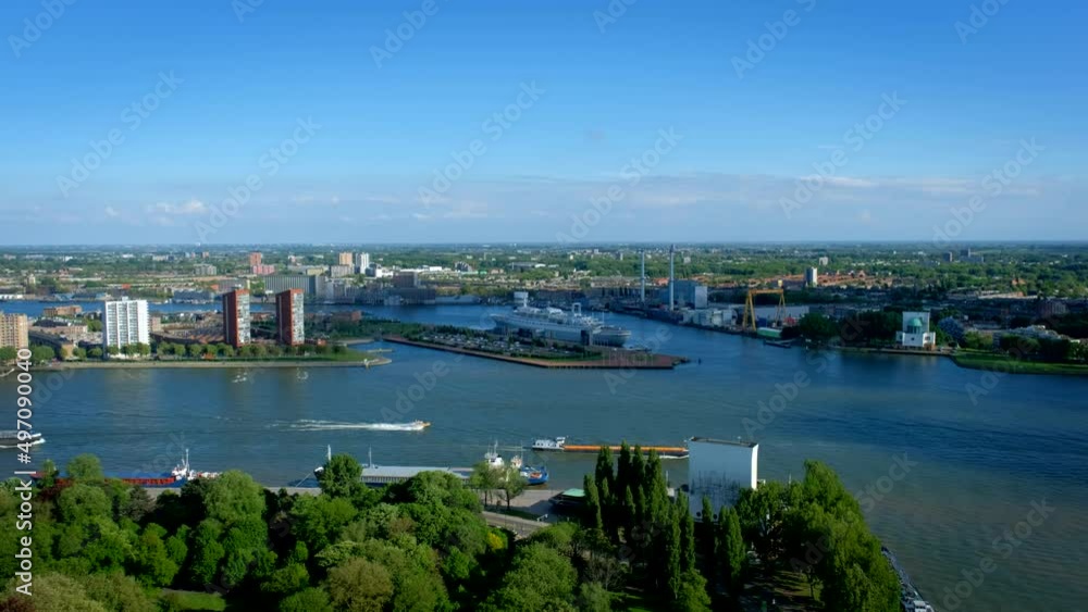 View of Rotterdam city with SS Rotterdam former ocean liner and cruise ship now hotel in Nieuwe Maas river with barges and boats from Euromast View of Rotterdam city with SS Rotterdam former ocean liner and cruise ship now hotel in Nieuwe Maas river with barges and boats from Euromast