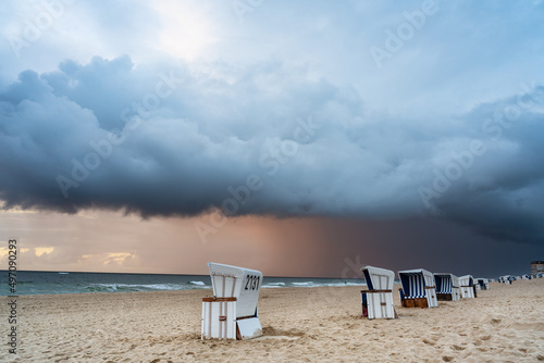 A dramatic storm cloud over the North Sea beach in Westerland. Sylt, Germany photo