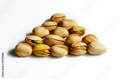 Peeled roasted pistachios isolated on white background