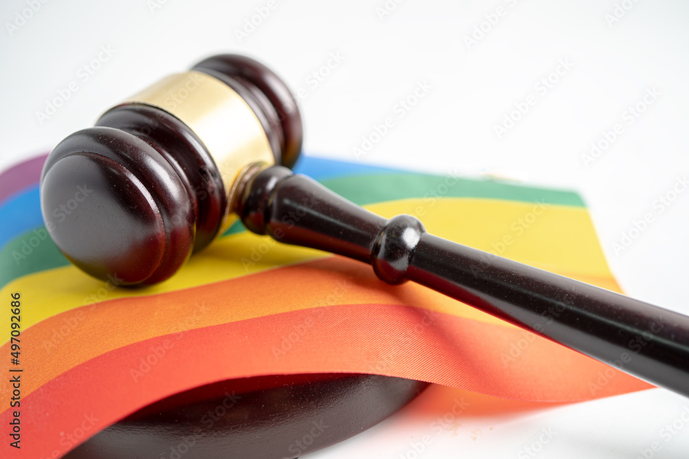 Gavel for judge lawyer on rainbow flag, symbol of LGBT pride month celebrate annual in June social of gay, lesbian, bisexual, transgender, human rights.