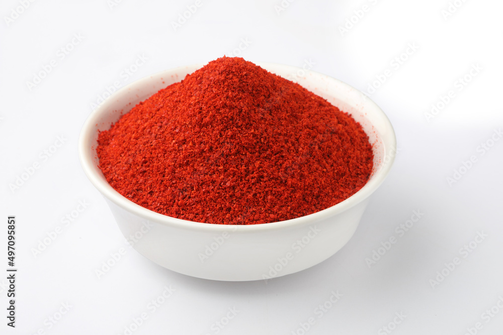 Indian spice Red chilli powder in white ceramic bowl Indian spice Red chilli powder in white ceramic bowl
