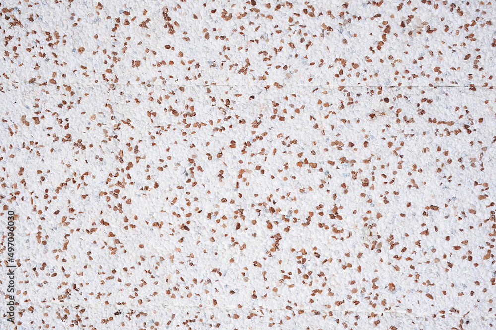 White and brown small pebble wall texture background. Interior or exterior decoration quality materials. White and brown small pebble wall texture background. Interior or exterior decoration quality materials.
