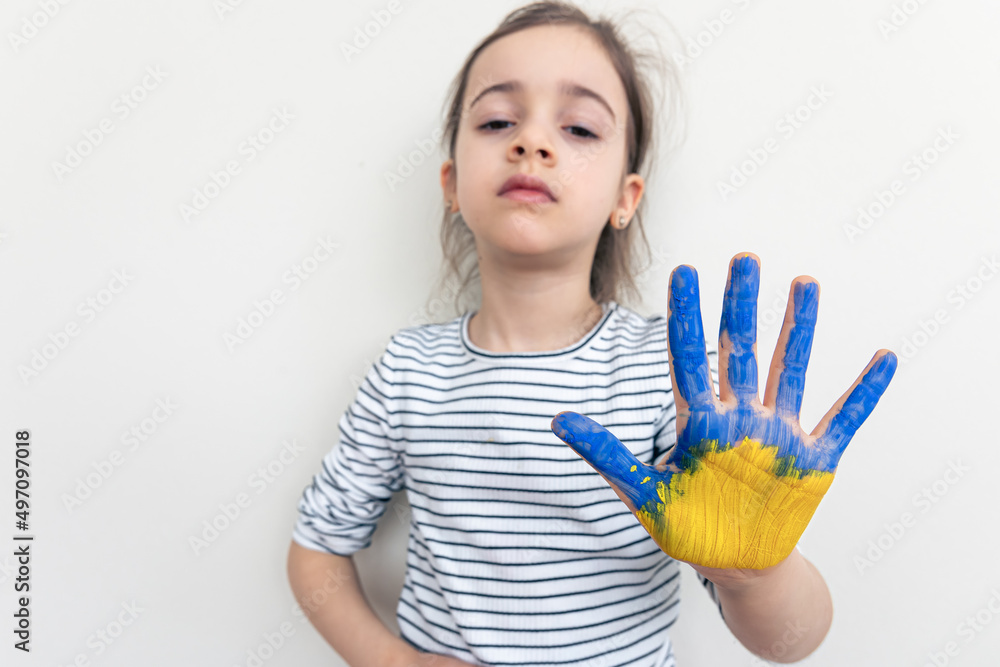 Child's hands painted on Ukraine flag colors. Child's hands painted on Ukraine flag colors.