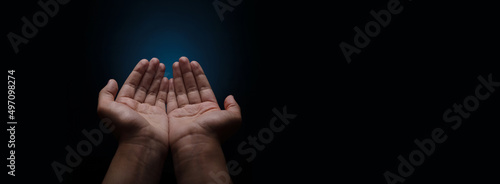 Schilderij op canvas Praying hands with faith in religion and belief in God on dark  background, palm