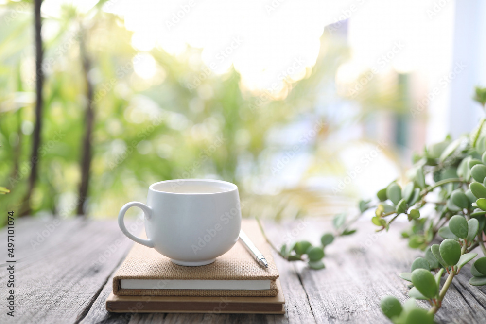 Small cup of coffee and notebooks and plant on wooden table Small cup of coffee and notebooks and plant on wooden table
