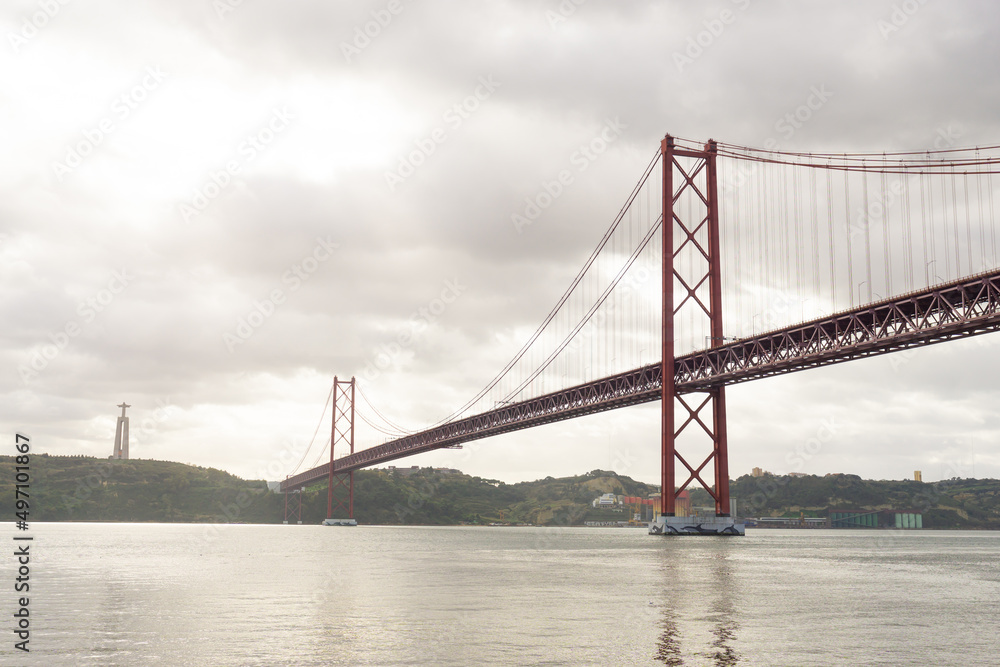 Fototapeta premium 25th of April bridge and Christ the King statue, in Lisbon - Portugal