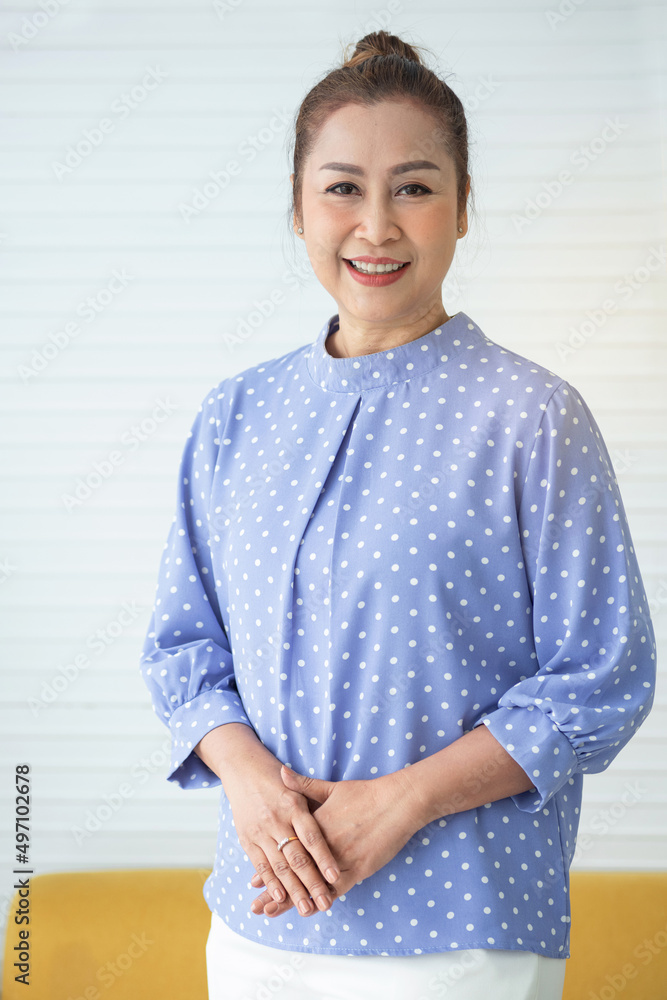 Asian middle age beautiful woman wearing casual shirt standing over white background, happy face smiling and looking at the camera, Positive person Asian middle age beautiful woman wearing casual shirt standing over white background, happy face smiling and looking at the camera, Positive person