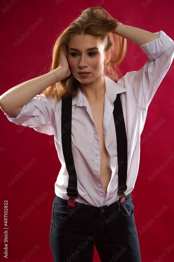 sexy girl in an unbuttoned shirt and suspenders Stock Photo