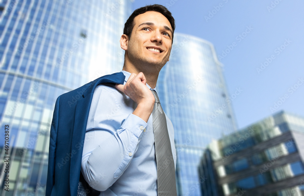 Fototapeta premium Businessman walking outdoor holding his jacket
