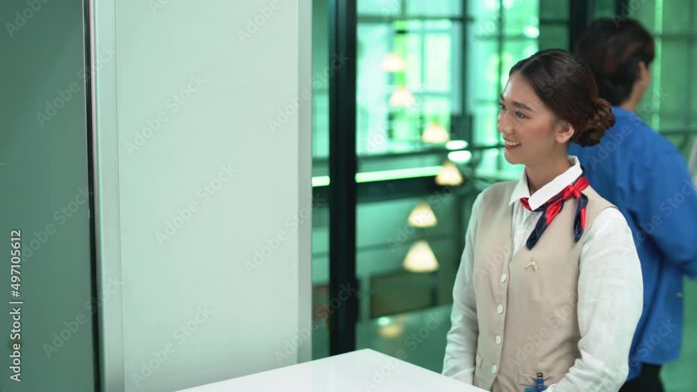Air hostess or cabin crew in gate checkpoint area service the passenger in the airport. Air hostess or cabin crew in gate checkpoint area service the passenger in the airport.