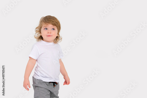Surprise on the face of a small child on a white background. Copy space . High quality photo