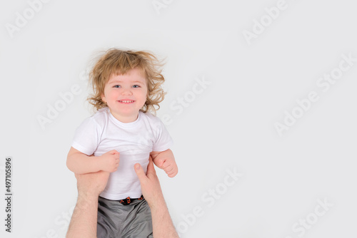 Dad throws a laughing child up. White background. Copy space . High quality photo © Oksana