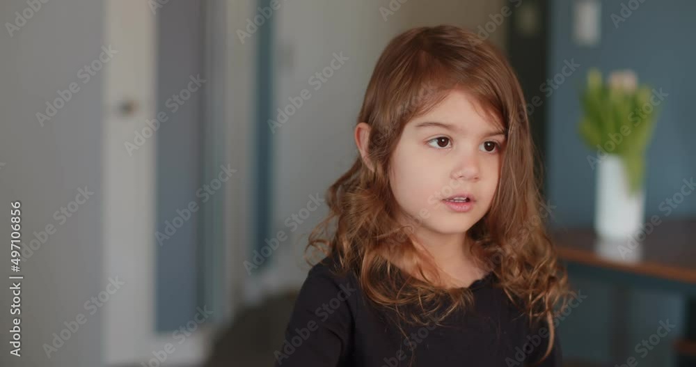 Cute toddler girl brushing her own hair. 4K footage.