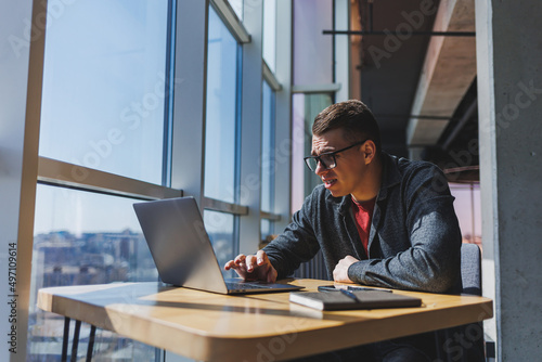 Professional manager working with business information, corporate money investment report, writing notes while doing online research on laptop computers, digital marketing