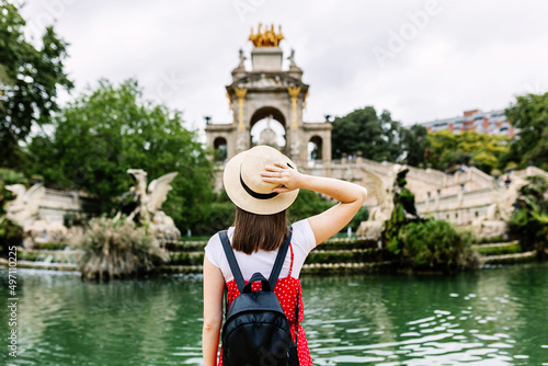 Young female tourist visiting Ciutadella Park in Barcelona - Hipster woman traveling in Spain during summer vacation - Holidays concept photo