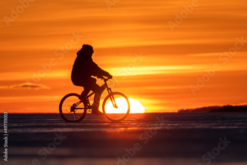 Silhouette of a cyclist at sunset