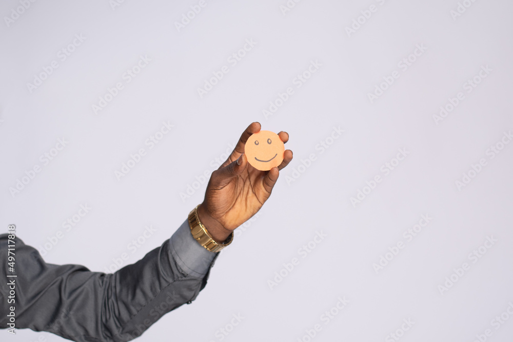 Fototapeta premium black man holding cardboard cutout smiling emoji face