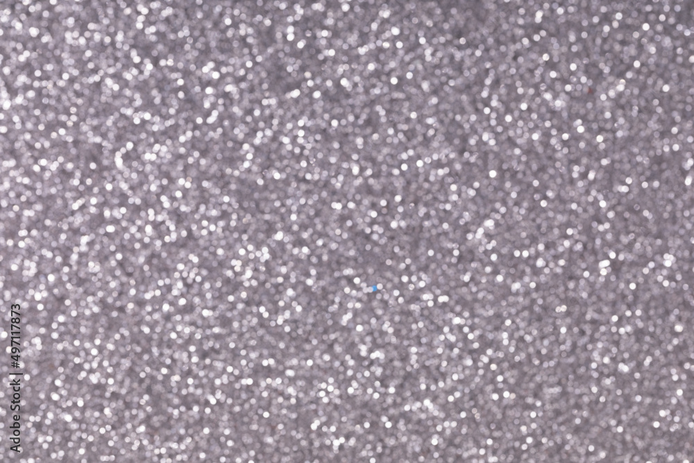 blurred close-up photo of silver sand, shot with depth of field, colored sand paper textured background