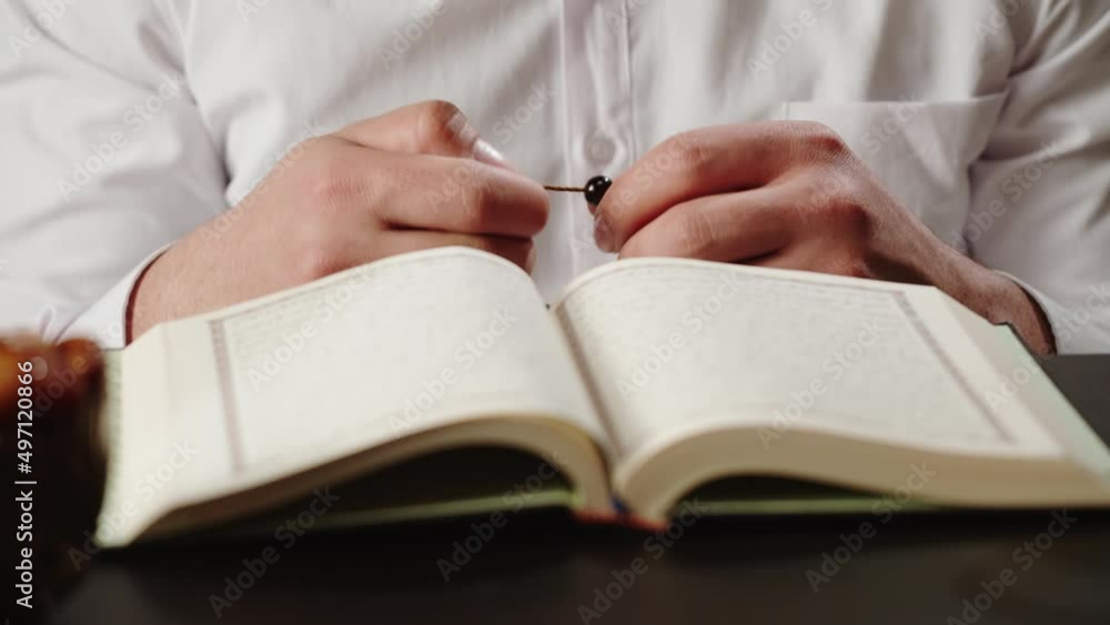 Man praying, reading quran close-up, islamic religion. Religious holiday Ramadan, holy month. Muslim worship, person making traditional prayer to God. Man praying, reading quran close-up, islamic religion. Religious holiday Ramadan, holy month. Muslim worship, person making traditional prayer to God.