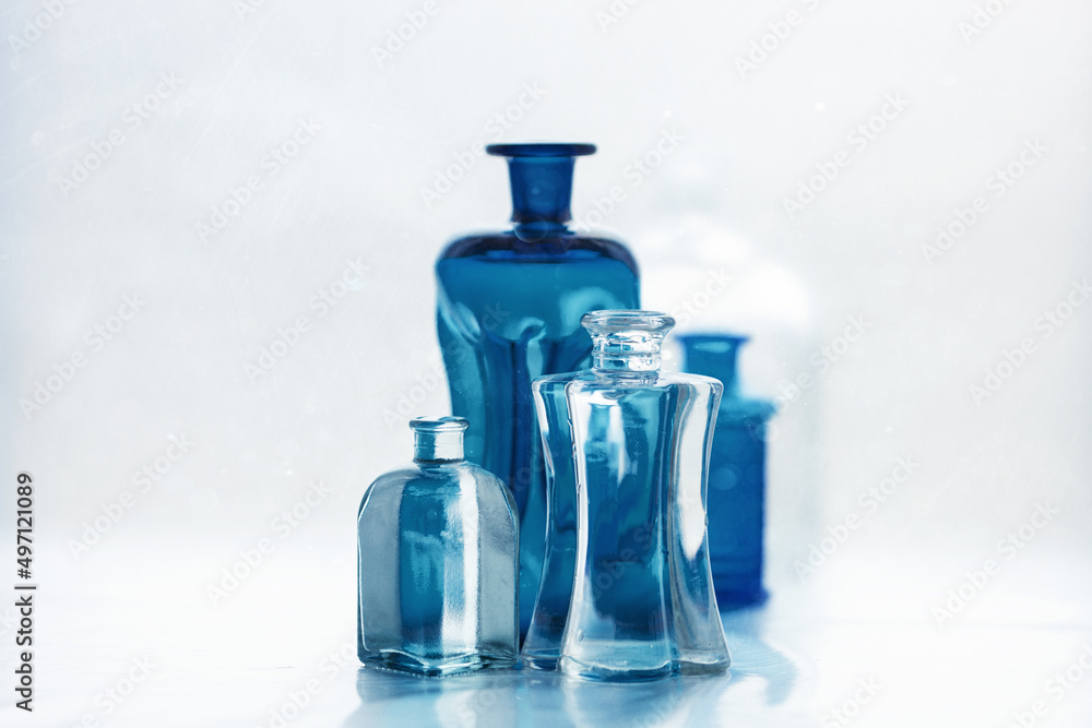 Arrangement with blue and transparent glass bottles. Arrangement with blue and transparent glass bottles.