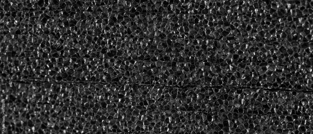 Fototapeta premium Black texture of porous packaging material.