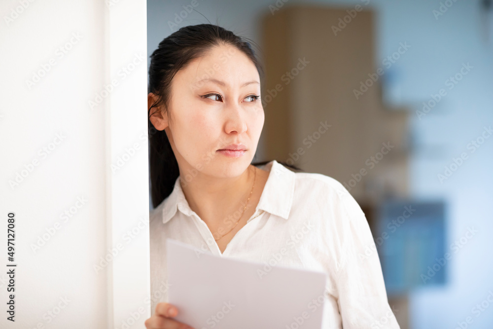 Pensive businesswoman with documents in office Pensive businesswoman with documents in office