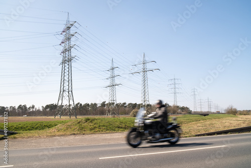 person riding a motorcycle power station electricity power pole