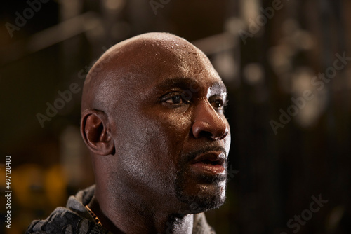 Close-up of man with sweat on face in gym photo