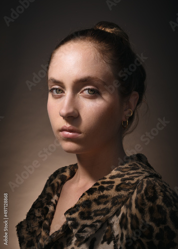 Studio portrait of serious woman wearing fake fur