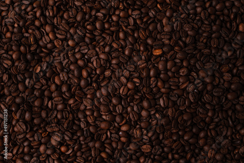 Many coffee beans spread out on a table