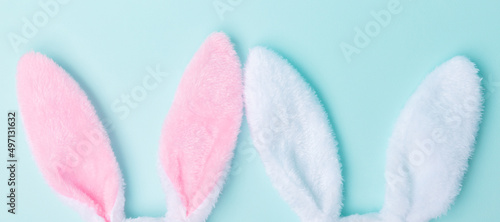 Toy bunny ears lie on the side on a blue background