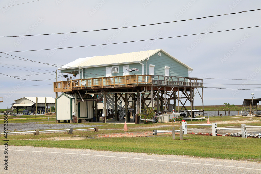 Obraz premium Schutz vor Sturmfluten in Louisiana. Grand Caillou Road, Boudreaux, Louisiana, USA -- Protection from storm surges in Louisiana. Grand Caillou Rd, Boudreaux, Louisiana, USA 