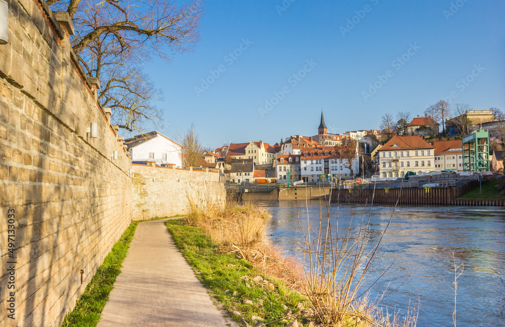 Walking path along the river bank of the Saale river in Bernburg, Germany