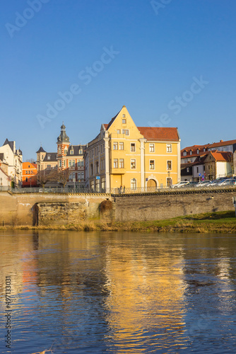 Old houses reflected in the Saale river in Bernburg, Germany