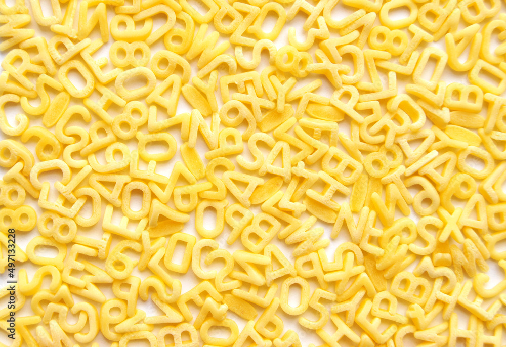 Alphabet pasta background, a top view of a surface of alphabet pasta on clean white background Alphabet pasta background, a top view of a surface of alphabet pasta on clean white background