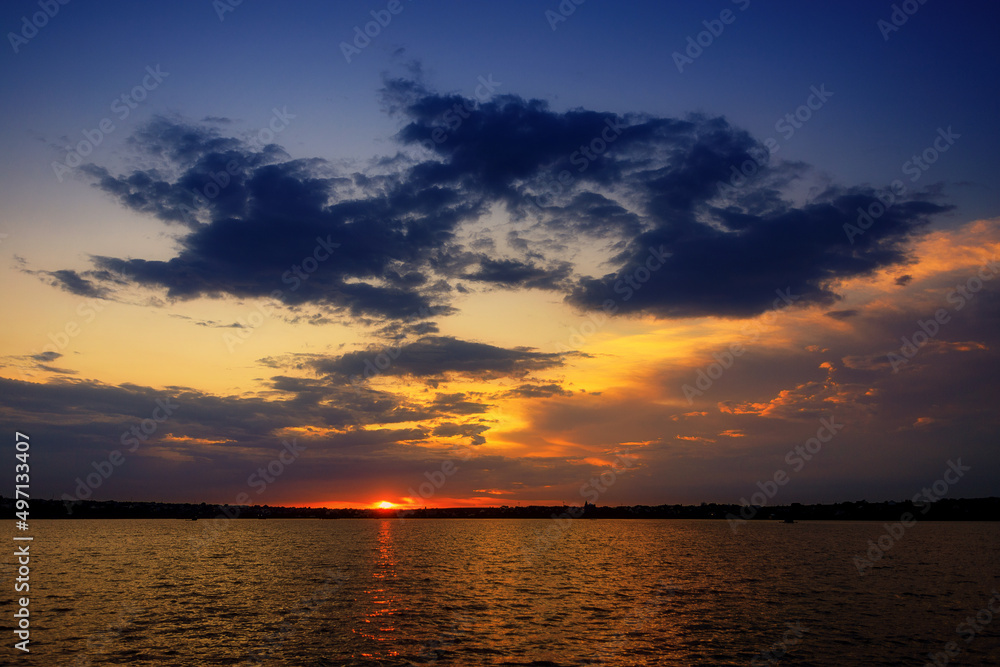 Beautiful sunset on the lake with clouds and reflections Beautiful sunset on the lake with clouds and reflections