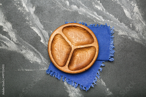 Empty wooden compartmental dish on a cement table, top view photo