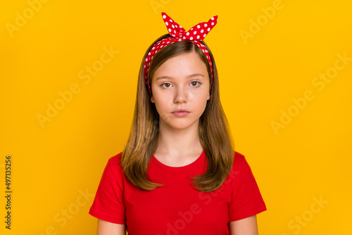 Photo of nice small girl wear red t-shirt headband isolated on yellow color background