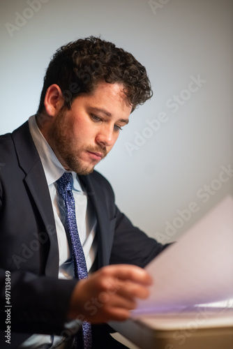 Business investor in deep thought. Man in suit reading papers, thinking, considering ideas. Business, job, occupation, late night work concept