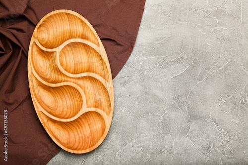 Empty wooden compartmental dish on a cement table, top view photo