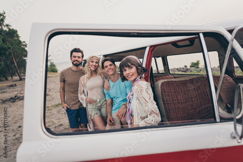 Photo of young hang-out couples near minivan stand wear t-shirt shorts outside in forest