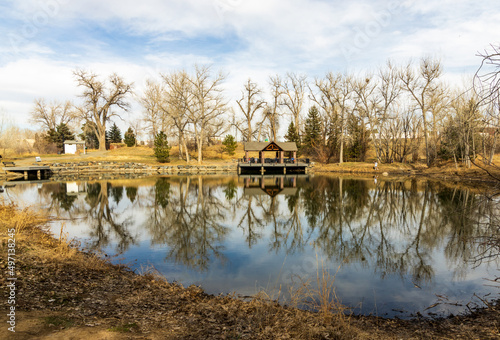 Beautiful early spring landscape with a pond and reflections in the small neighborhood Fly'n B Park in Highland Ranch, Colorado