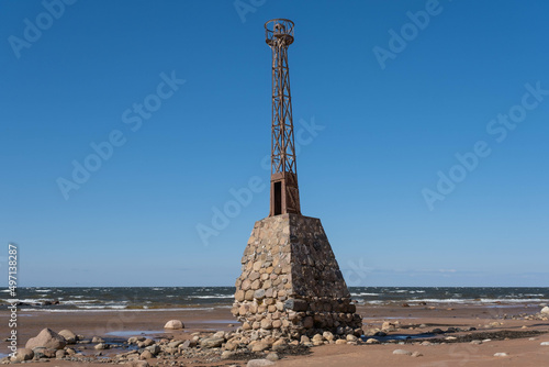 old ruins of Kurmrags Lighthouse on the shore of the Rigas Gulf, Baltic sea, Latvia, aerial view. photo