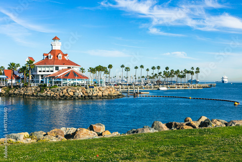 Shoreline Village in Rainbow Harbor In Long Beach, California. Shops line the edge of the marina area, and boats are docked in it's harbor.