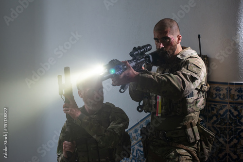 Fotografering Alert military men during battle