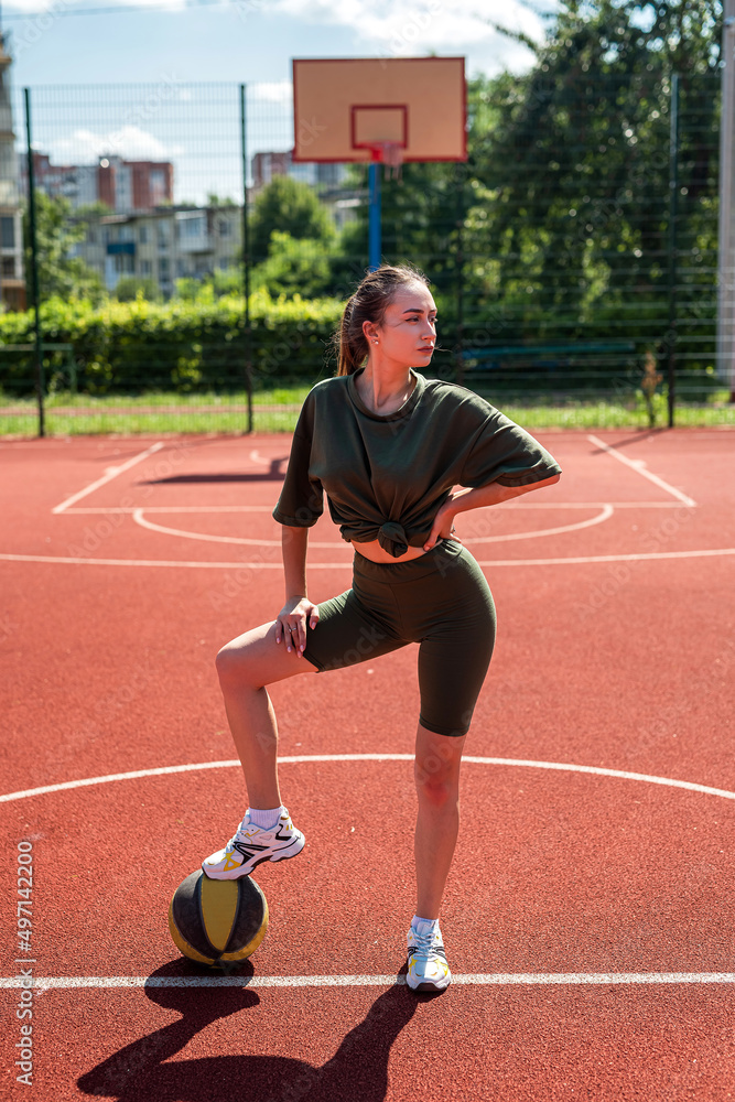 charm young woman with basketball on sports playground